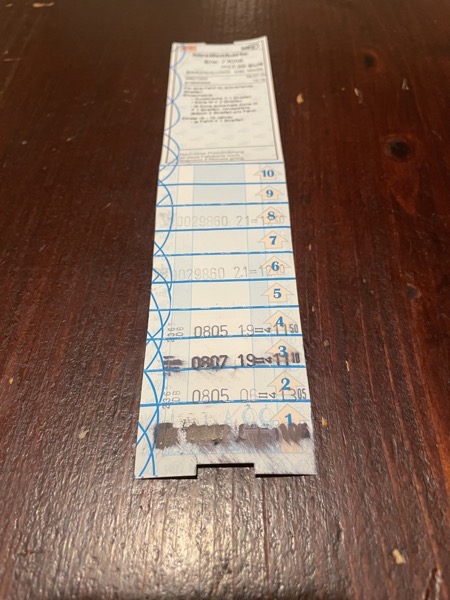 a Munich stripe ticket on a table. 8 stripes are stamped, the first stamped is smudged and not legible