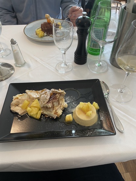 dessert mista on a black sqaure plate, tartufo ice on a pale blue plate, everything with fresh pineapple and a glass of moscato wine
