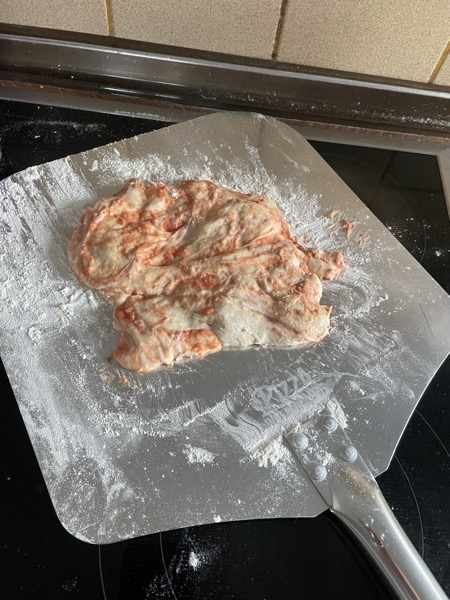 and the one poor pizza we had to chuck because we never managed to transfer it from the towel to the peel to the oven; this is a blob of dough mixed with sauce that stuck to the peel so hard we never got it off in one piece