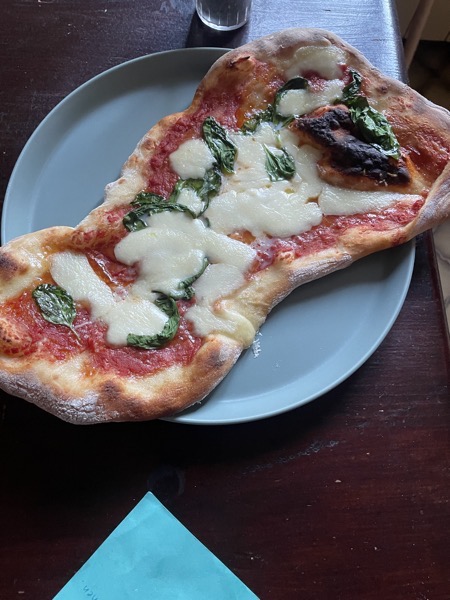 pizza ready to be eaten on a gray-green plate