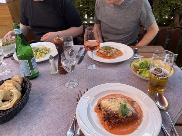 a restaurant table with lots of glasses and plates